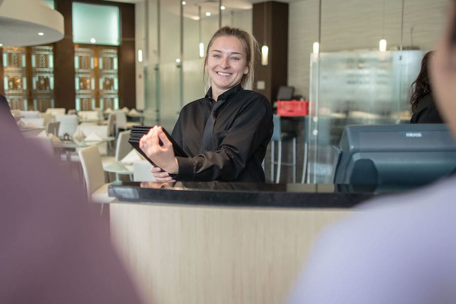 Student is pictured in HTM Restaurant.