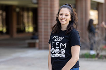 A PNW student outdoors in a PNW STEM on the Road shirt