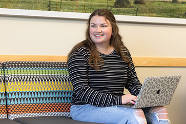 A PNW student works on a laptop