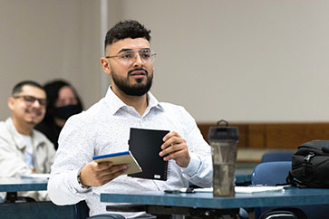 A PNW student takes notes in the classroom