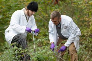 Professor and student working in a field