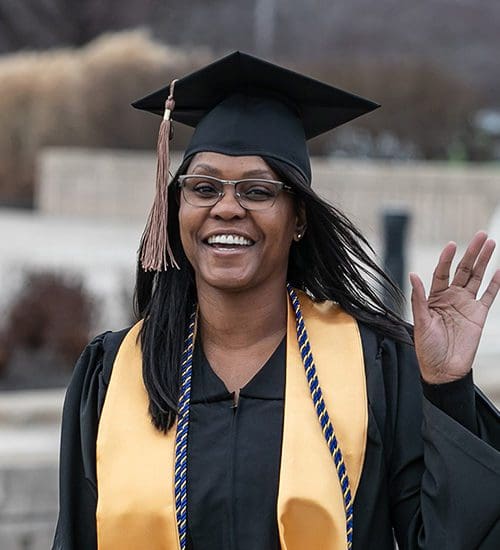 A student waves at PNW's commencement