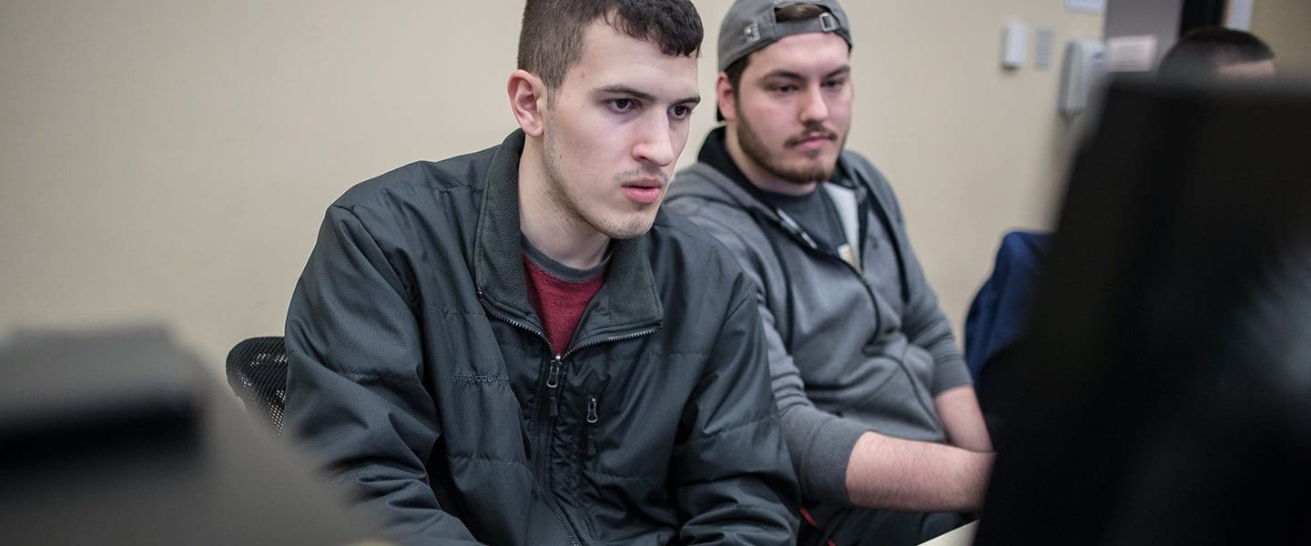 Students looking at a computer together