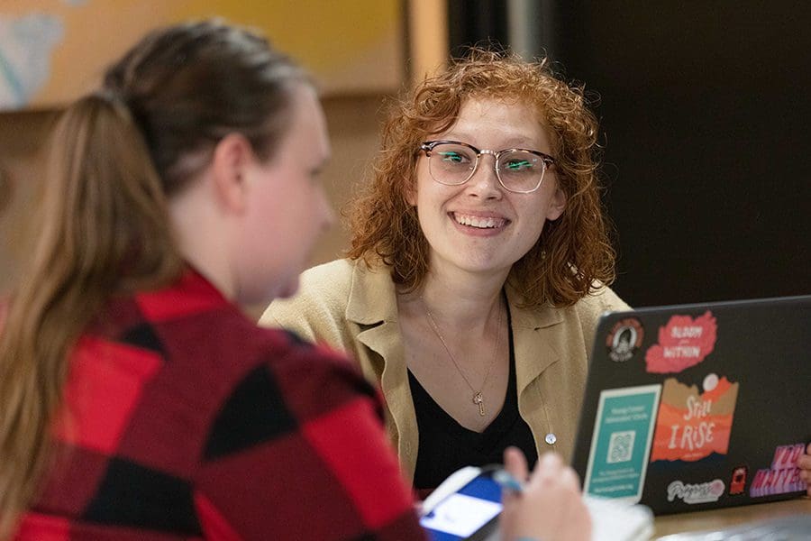 Female student looking at another student