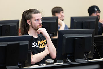 Student sits behind a computer