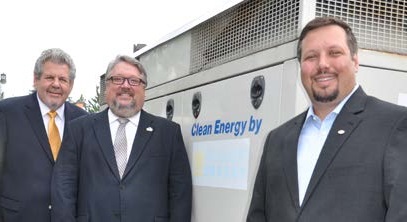 Pictured left to right: Glenn Lubeznik, PNW Dean of the College of Engineering and Sciences Chris Holford and Sam Lubeznik stand next to the cogeneration unit donated to the university