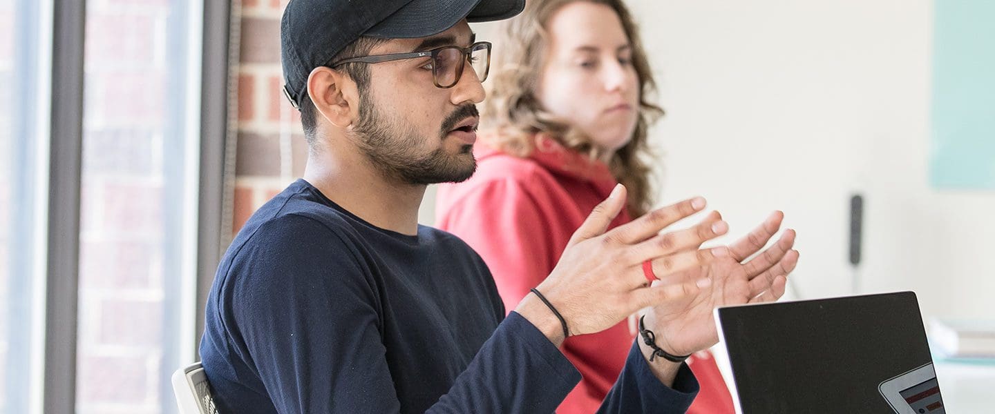 male student talking in class