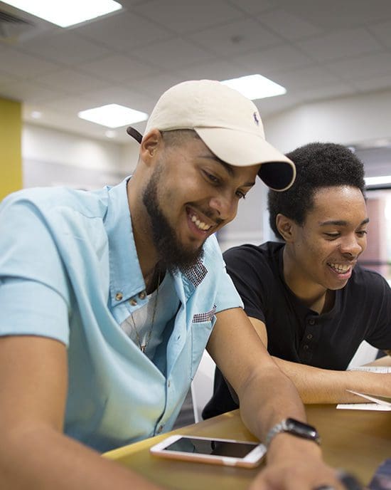 Two students work together in the classroom.