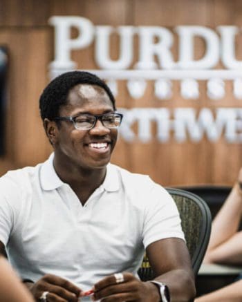 A student smiles in the classroom