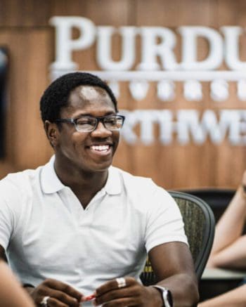 A student smiles in the classroom