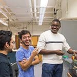 Students laugh in the laboratory.