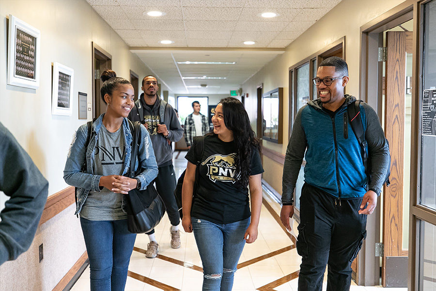 PNW Students walk through a hallway