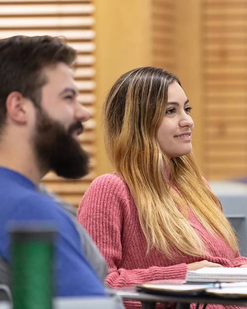 Two students listen in the classroom.