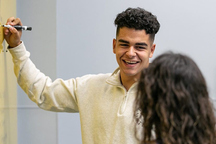 Student laughing while teaching.