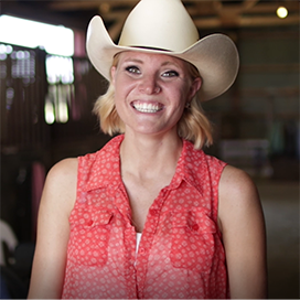 Anna Marie Gianni standing with cowboy hat. 