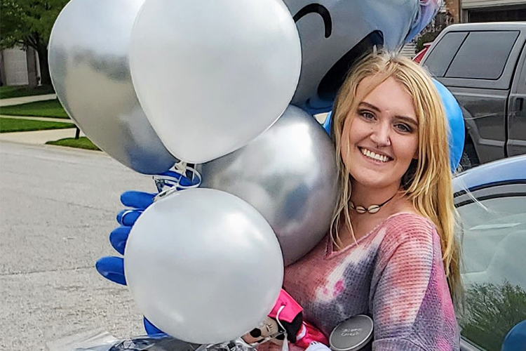 Samantha Frederick graciously receives gifts during her “Welcome to Purdue Northwest” car parade.