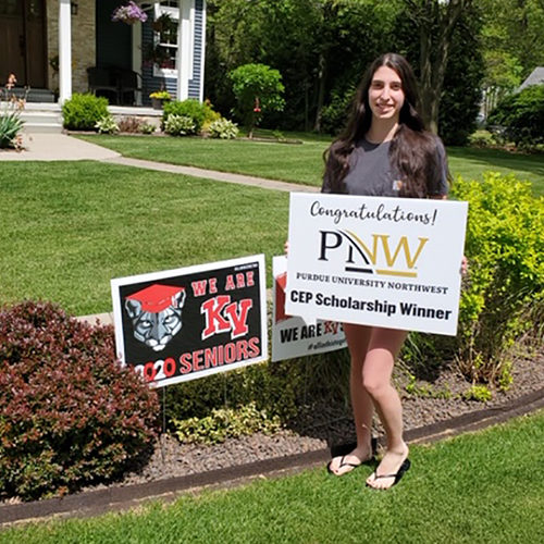 Audry Wright proudly holds a congratulatory sign presented to her from Purdue Northwest’s Concurrent Enrollment Program representatives.
