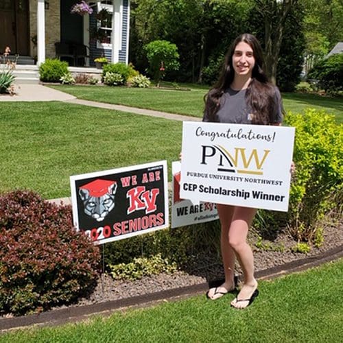 Audry Wright proudly holds a congratulatory sign presented to her from Purdue Northwest’s Concurrent Enrollment Program representatives.