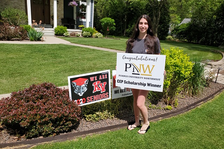 Audry Wright proudly holds a congratulatory sign presented to her from Purdue Northwest’s Concurrent Enrollment Program representatives.