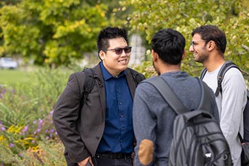 Three PNW students talking outside on campus 363x242