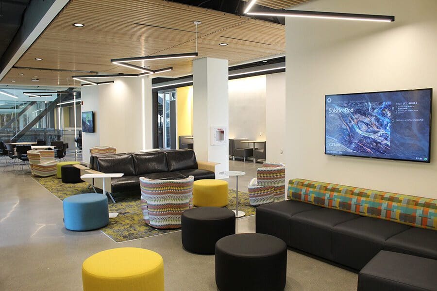 Stools and screens in the Nils K Nelson Bioscience Innovation Building's lobby.