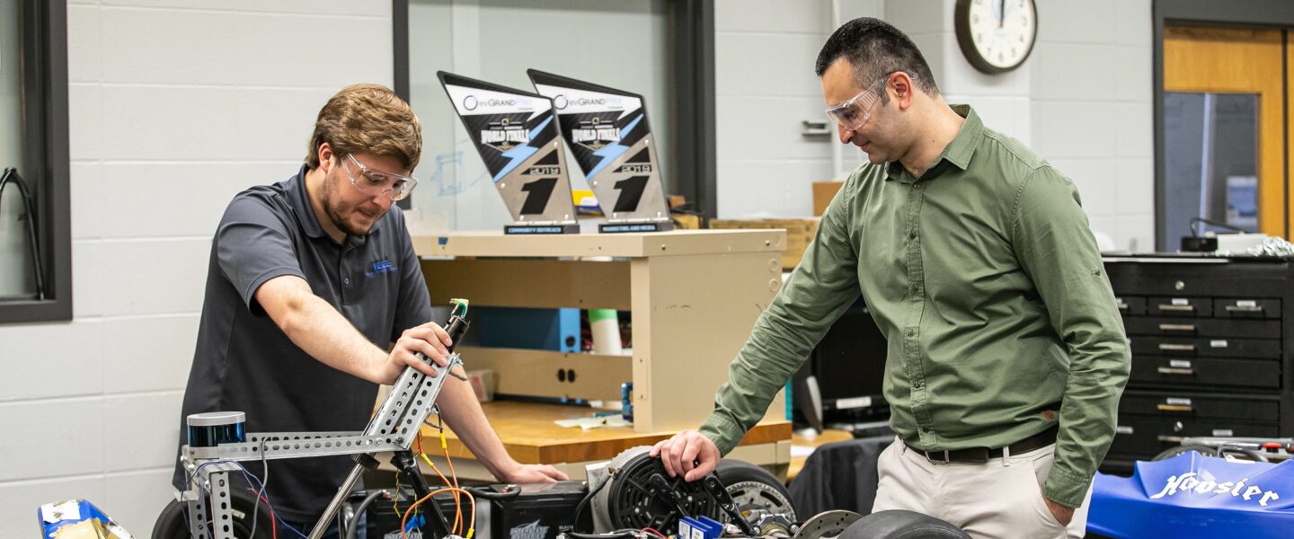 Khair Al Shamaileh, PNW assistant professor of Electrical Engineering, works with a student in an engineering lab. Fifteen PNW engineering students from East Chicago, Hammond and Whiting recently received scholarship funds from bp America, Inc.