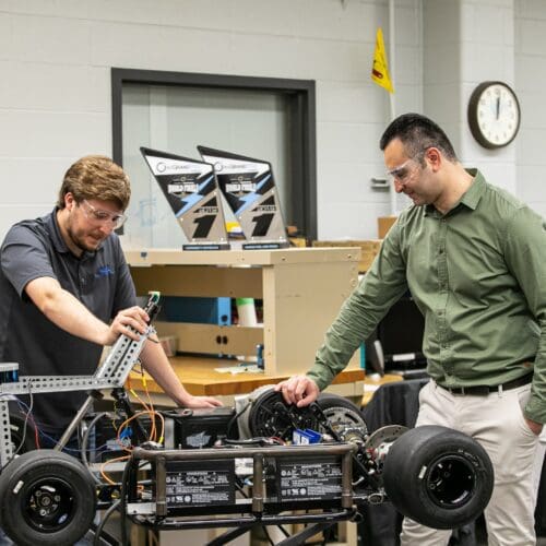 Khair Al Shamaileh, PNW assistant professor of Electrical Engineering, works with a student in an engineering lab. Fifteen PNW engineering students from East Chicago, Hammond and Whiting recently received scholarship funds from bp America, Inc.