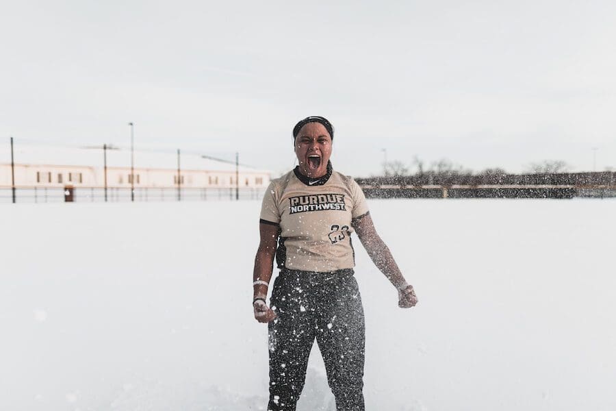 Student playing sports in snow.