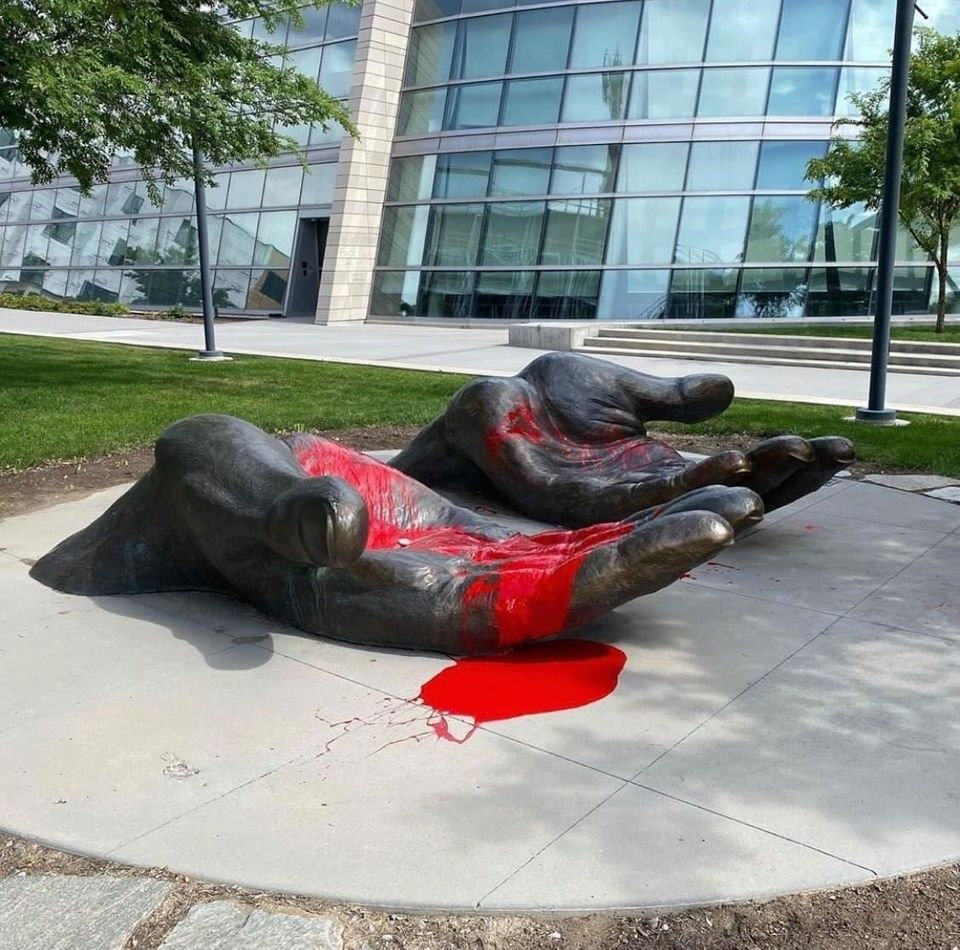 Image of sculpture of fallen hands.