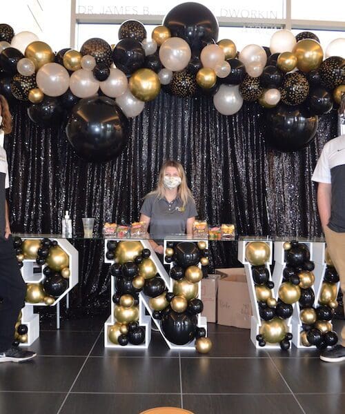 Students standing in front of PNW swag.