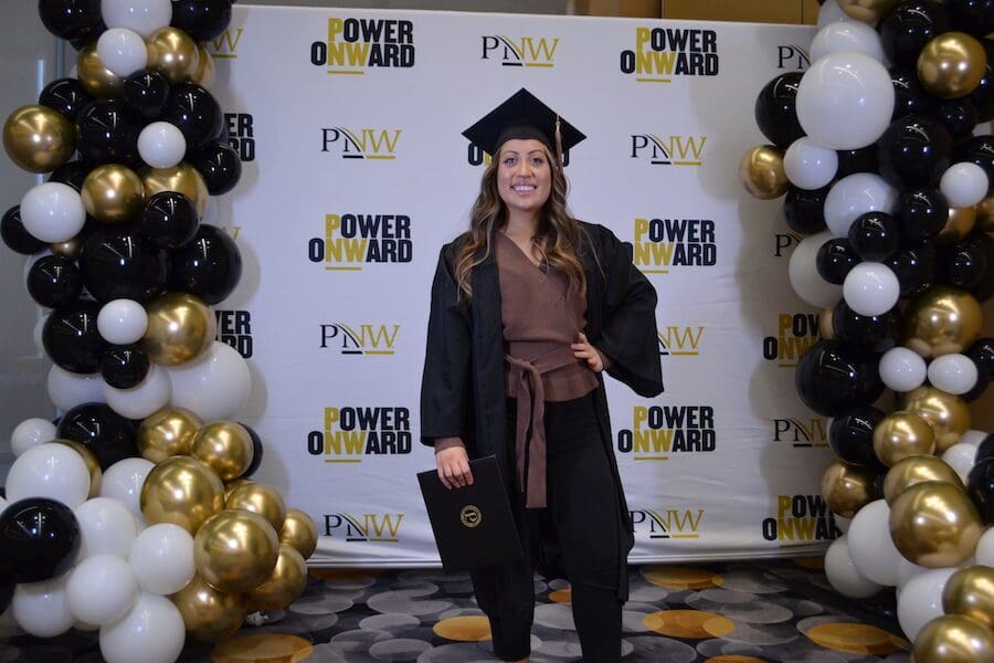 Student pictured in front of balloons.