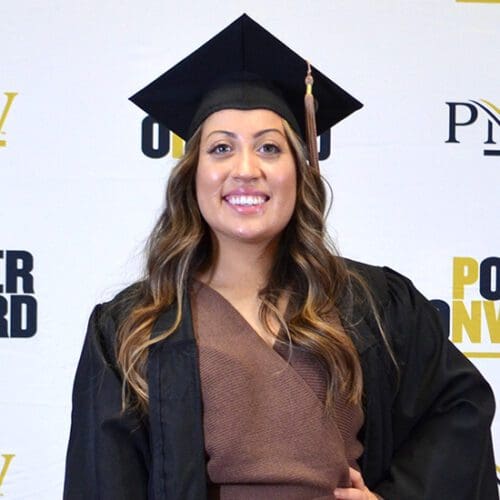 A Fall 2020 PNW grad poses in her cap.