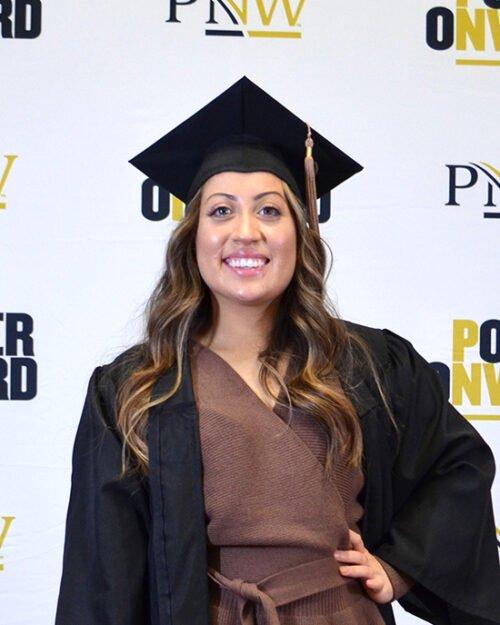 A Fall 2020 PNW grad poses in her cap.