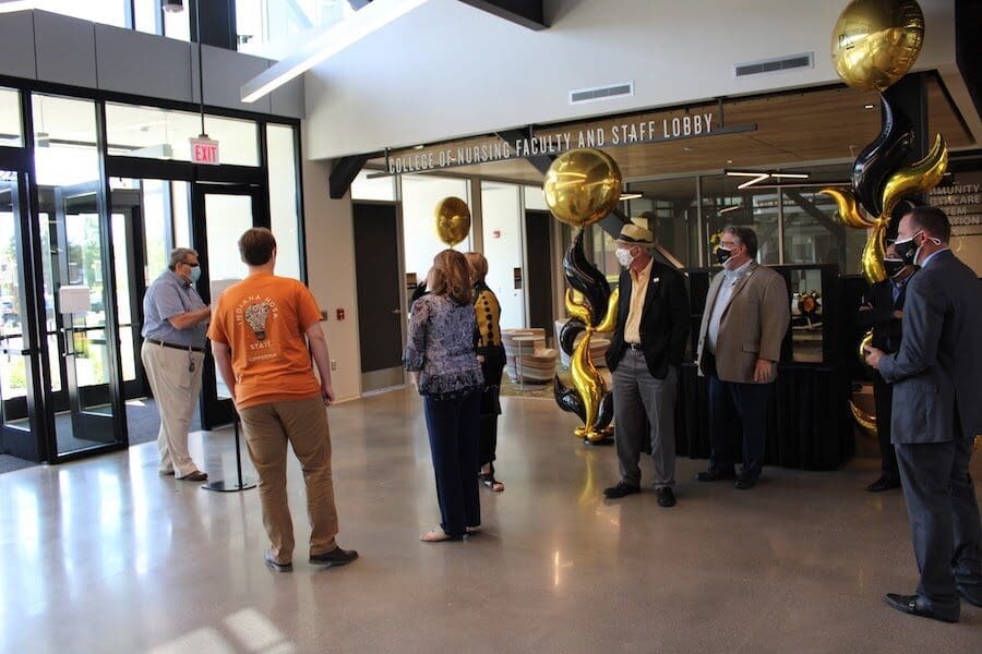 Gathering for ribbon cutting is pictured.