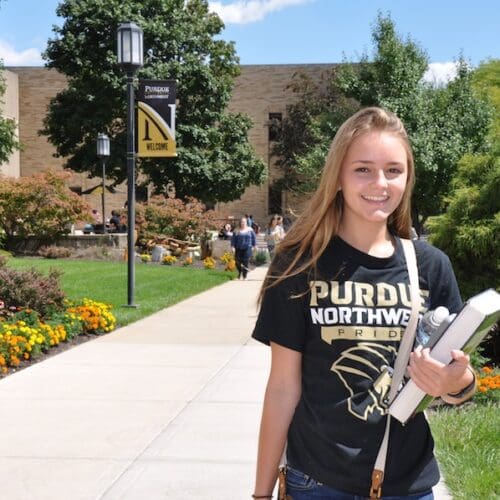 A student is smiling on campus.