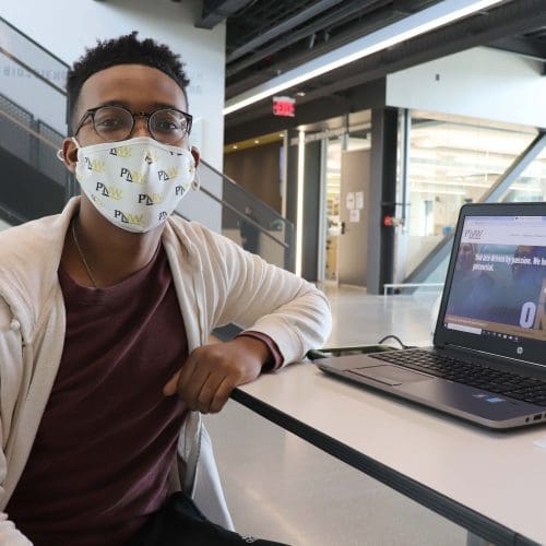 Purdue Northwest senior Gerald Akujobi volunteers at check-in during a COVID-19 vaccination clinic at the Nils K. Nelson Bioscience Innovation Building.