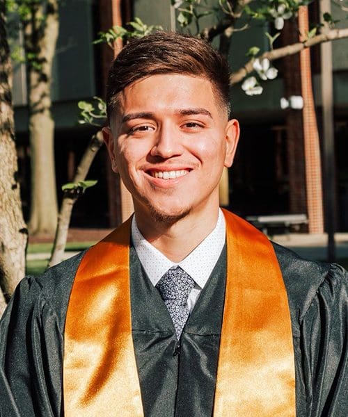 Spring 2021 Graduate Adrian Nevarez in his commencement regalia