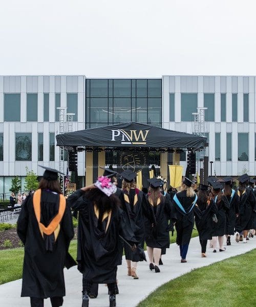 Students walking in commencement 2021.