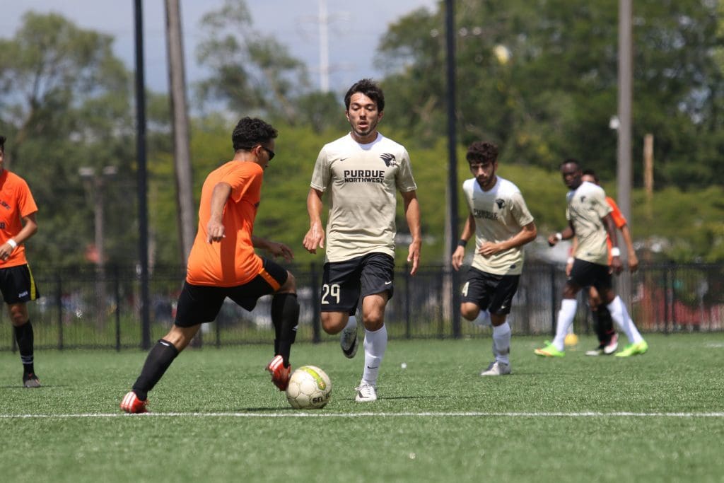 A PNW soccer player advances the ball up the field