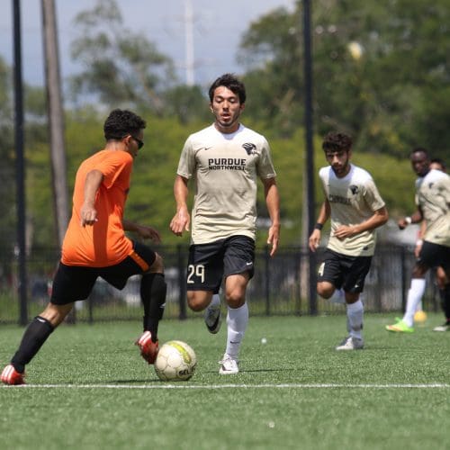 A PNW soccer player advances the ball up the field