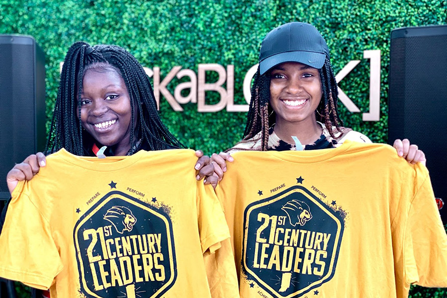 Students holding 21st Century Leaders t-shirts