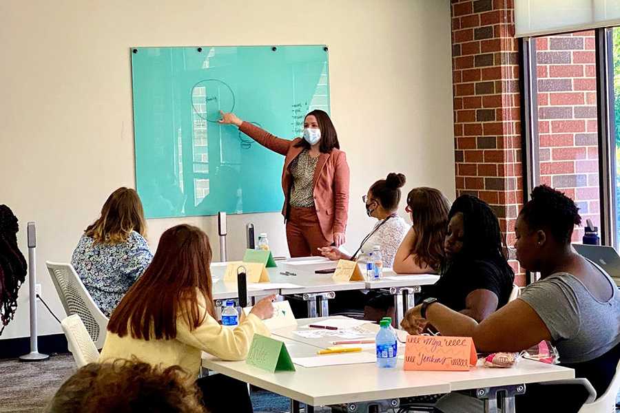 A professor speaks in a classroom