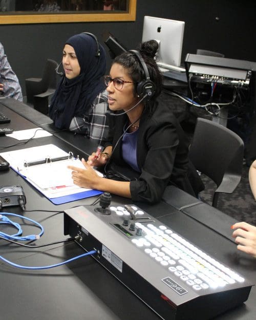 PNW broadcast students sit at the production table