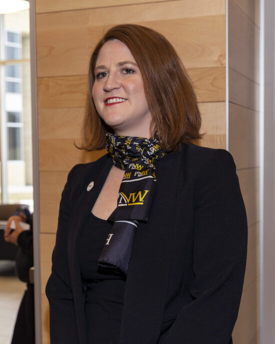 A staff member in PNW apparel at Founders Day.