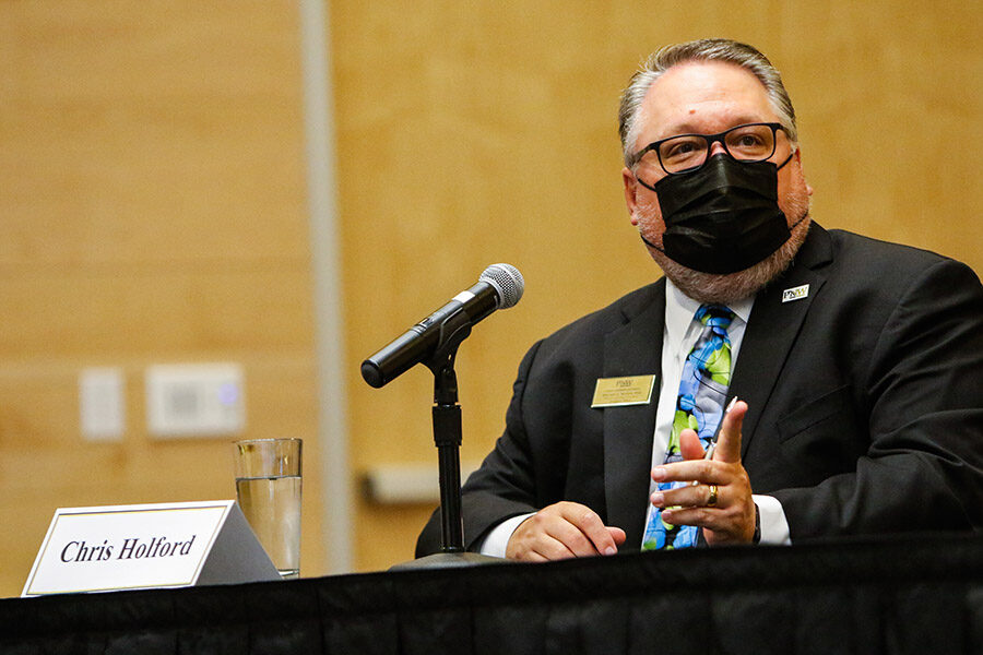 Provost Chris Holford speaks in a mask