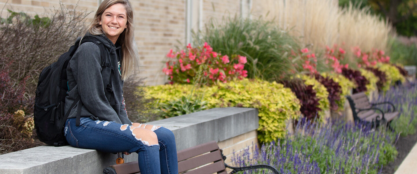 A student sits outdoors on PNW's Westville campus
