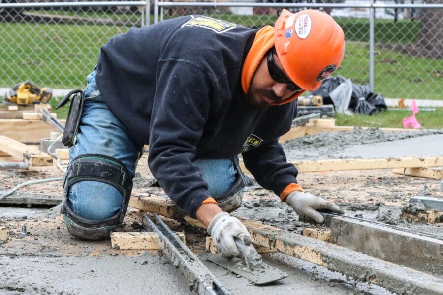 Larson-Danielson construction workers smooth out freshly poured cement for the base of a new bell tower on Nov. 9.