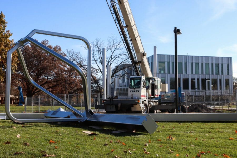 Steel beams and pieces for a new bell tower on the Hammond campus lay on the ground awaiting installment.