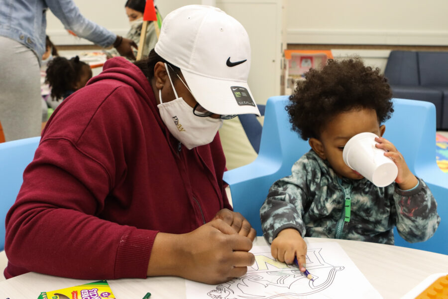 PNW Student Amari Norwood, left, colors with her son, Isaiah Woodson, during an open house at the student-family lounge in the Classroom Office Building on the Hammond campus.