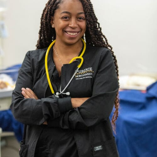 A PNW nursing student wearing a stethoscope in an exam room.